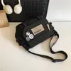 Nova Bolsa de Ombro 2024 Masculina Casual Versátil Estudante Bolsa Transversal Marca da Moda Estilo Ferramenta Bolsa Mensageiro para Casal
