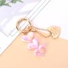 Llavero con colgante de coche con forma de corazón, cadena creativa con cuentas, accesorios pequeños y frescos para auriculares y bolsos.