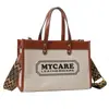 Bolsa Feminina de Lona Transfronteiriça 2025 Nova Moda Simples Estampa de Letras Bolsa de Mão Bolsa de Ombro Transversal Bolsa Tote