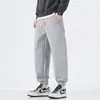 Pantalones casuales negros para hombre, corte holgado con puños, nuevos pantalones deportivos de marca de moda con cordón otoño 2026, versátiles pantalones de chándal de punto