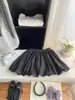 Falda de Cuadros Retro con Botones para Persona Pequeña Falda Media para Mujer Verano 2026 Versátil Anti-Exposición Falda Corta de Corte A Serie Blanco y Negro Esponjosa