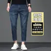 Jeans elásticos de 8/9 de largo para hombre Guangzhou Xintang, modernos y versátiles para primavera y otoño, de moda para personas bajas de 160 cm