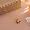 Pendientes de trébol de cuatro hojas del mismo estilo de la serie Wanxiang de la joyería de oro, pendientes y conjunto de collar de moda nicho de tendencia china exquisitos al por mayor