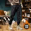 Pantalones de trabajo lavados al agua marca de moda pantalones de chándal desgastados para hombre peso pesado retro casual pantalones para hombre con puños forrados de forro polar pantalones largos de senderismo