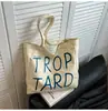 Bolsa de Lona Casual de Cor Contrastante Estilo Coreano para Mulheres 2025 Nova Bolsa de Ombro com Letras Estudante Deslocamento Simples Versátil Bolsa de Mão