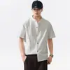 Camisa de manga corta de color liso con cuello mao de estilo chino de alta gama para hombre, marca de tendencia verano 2026, camisa casual suelta texturizada al por mayor