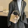 Bolso de mano de alta gama, nicho, para mujer, 2026, nuevo, retro, versátil, bandolera, bolsa tipo cubo, muy popular, para ir al trabajo