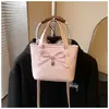 Bolso de mano de nicho con lazo para mujer, nuevo modelo 2026, bolso tipo cubo con textura de piel aceitada, bolso cruzado de moda para el día a día