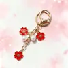 Colgante de llavero de aleación de doble flor más vendido transfronterizo, con lindos accesorios de flor de cerezo y perlas, adecuado para fundas de auriculares y bolsos