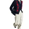 Cardigan de punto jacquard con patrón de diamantes en bloques de color estilo universitario chaqueta corta para mujer otoño nuevo botones pequeños suéter suave y acogedor