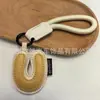 Venta al por mayor transfronteriza de llaveros japoneses y coreanos con letras en inglés, dijes para bolso de cuero dopamina, pequeños accesorios y regalos