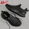 Zapatillas para hombre Warrior 2026 verano nuevas transpirables casuales zapatillas ligeras para correr zapatillas de punto fly-knit para hombre