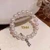 Pulseira Clássica de Pérolas para Mulheres, Semelhante ao Estilo da Shijia, com um Toque de Luxo Leve e Sofisticado, Apresentando Cordão Elástico e Delicadas Miçangas de Arroz para Empilhamento