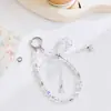 Elegante cordón para teléfono con lazo de cristal y perla, accesorio hecho a mano con cuentas rosas para niñas, amuleto anti-pérdida para bolso, cadena para bolso de mano