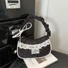 Bolso de lunares de nicho súper popular para mujer, nuevo bolso de moda 2026 versátil para hombro y axila, bolso de mano pequeño exquisito