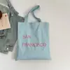 Bolsa Tote de Lona Moda de Nicho 2026 Nova Coleção de Primavera Estilo Letras para o Dia a Dia Elegante Grande Capacidade Bolsa de Ombro Leve