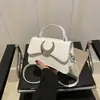 Comércio Exterior Transfronteiriço 2024 Nova Bolsa Feminina High-end Fecho de Lua Pequena Quadrada Moda Tendência Bolsa de Ombro Transversal