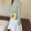 Exquisita mini bolsa de nicho con estampado de lichi para mujer, nueva moda 2026, bolso cruzado versátil, bolso cubo súper popular para teléfono