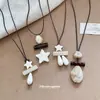 Nuevo collar retro estilo chino de piedra acrílica con estrella, cadena para suéter de nicho de verano de alta gama, accesorio moderno y versátil