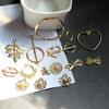 Accesorios para orejas DIY Aleación coreana Simple Perla Flor Amor Lazo Material para aretes Pulsera Colgante
