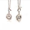 Collar giratorio de cara sonriente acero de titanio expresión giratoria hip hop estado de ánimo inverso artístico hombres y mujeres colgante de cara llorando joyería moderno nuevo