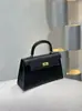 Bolso Kelly de alta gama con hebilla plateada y estampado de palmeras 2026 nueva moda para mujer segunda generación bolso de mano con hebilla dorada bolso de hombro bolso cruzado