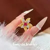 Anillo de flor de corindón rojo estilo diosa de lujo de alta gama, incrustado con diamantes, diseño de pétalos vintage de alta resistencia, anillo único y lujoso