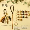 Kit de material DIY para fazer um móbile de casca de fruta, um sino pendurado de cura, com frutas pretas indonésias, estramônio, lírio d'água e rotim