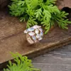 Anillo elástico de flor geométrica hueca de nuevo color esmaltado transfronterizo, moda femenina, racimo de flores versátil, anillo de alta gama