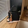 Moda transfronteriza simple y elegante estilo coreano diseño de nicho bolso de hombro cruzado casual, bolso de mano de color sólido moderno tipo cubo