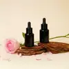 En stock: Botella de vidrio para aceite esencial de 15 ml, transparente, con hombro inclinado y gotero; Botella de vidrio para sérum de 30 ml con gotero; Botella dispensadora de vidrio para líquido original