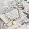 2025 Novo Bracelete de Lótus de Jade Branco Bracelete de Cristal Nicho Alto Padrão Luxo Acessível Exquisito Estilo Fada Bracelete