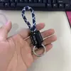 Llavero de cuerda tejida a mano de cuero para coche personalidad creativo colgante de llave patrón de texto imprimible venta al por mayor de fábrica
