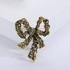 Broche de diamantes de imitación creativo de gran venta transfronteriza, aleación galvanizada, lazo vintage, ramillete para mujer, accesorios de ropa de alta gama.