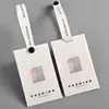Etiquetas personalizadas de marca de alta gama y moda, tarjeta semitransparente, papel especial, broche anti-falsificación, diseño e impresión de etiquetas para ropa, venta directa del fabricante