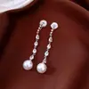Pendientes de borla con flor de trébol de circonita vintage con un toque de alta gama, pendientes versátiles y de moda al por mayor
