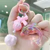 Chaveiro de Golfinho a Laser da Moda com Bolinha de Pelúcia Fofa e Laço, Pingente de Bolsa para Meninas, Acessório de Chave Colorido Sonhador