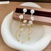 Pendientes de borla de flor de concha blanca transfronterizos europeos y americanos con perlas, pendientes de estilo de corte francés, pendientes ligeros y lujosos con un toque de alta gama