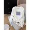 Estilo novo de 2026, corte regular, algodão floco de neve, gola redonda, manga longa, camiseta para mulheres, moderna e versátil, camada interna branca, estilo fino de outono