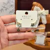 Pendientes de estrella estilo Ins, geniales y elegantes, para mujer, pendientes de botón de lujo ligero, nicho, alta gama, joyería para orejas versátil y de moda, venta al por mayor