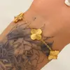 Conjunto de joias de aço inoxidável banhado a ouro 18K, pulseira, colar e brincos personalizados com trevo de quatro folhas rotativo gravado para mulheres, versátil para atacado
