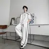 Conjunto de camisetas deportivas casuales de manga corta de alta gama para hombre, con un diseño único de bloques de color y pantalones largos de pierna ancha