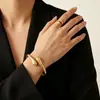 Set metálico de gota de agua geométrica transfronteriza, pulsera abierta y anillo set de dos piezas, accesorios de lujo ligero de alta gama al por mayor
