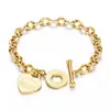 Joias de aço titânio transfronteiriças para mulheres, pulseira da moda com fecho OT e pingente de coração, pulseira de casal em formato de coração com letra em inglês