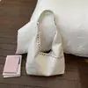 Bolsa Tote Personalizada com Rebites Cor Sólida de Grande Capacidade Design de Nicho para Mulheres 2026 Primavera Novo Estilo Bolsa de Ombro Único