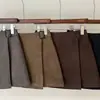 Saia outono nova assimétrica elegante com cinto lateral, cintura alta, afina a silhueta, saia evasê anti-exposição