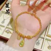 Tienda de Oro Mismo Estilo Arena Dorada Trébol de Cuatro Hojas Calabaza Ojo de Gato Pulsera para Mujer, Pulsera Versátil de Moda "Hazte Rico Ahora" Venta al por Mayor
