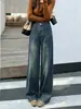 Calça jeans retro azul de perna larga e corte curvo para mulheres, novo design outono/inverno 2026, calça solta de perna reta e comprimento até o chão para mulheres