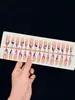 Uñas postizas de alta gama hechas a mano para comercio exterior en rosa nude y blanco con diseños tallados y baño de oro, disponibles para venta al por mayor