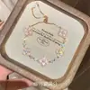 Nuevo Pulsera Versátil Estilo Chino para Mujer Sensación de Alta Gama Diseño de Cuerda Tejida a Mano de Zorro Circonita Cúbica Rosa Trébol de Cuatro Hojas Pulsera de Lujo Ligero